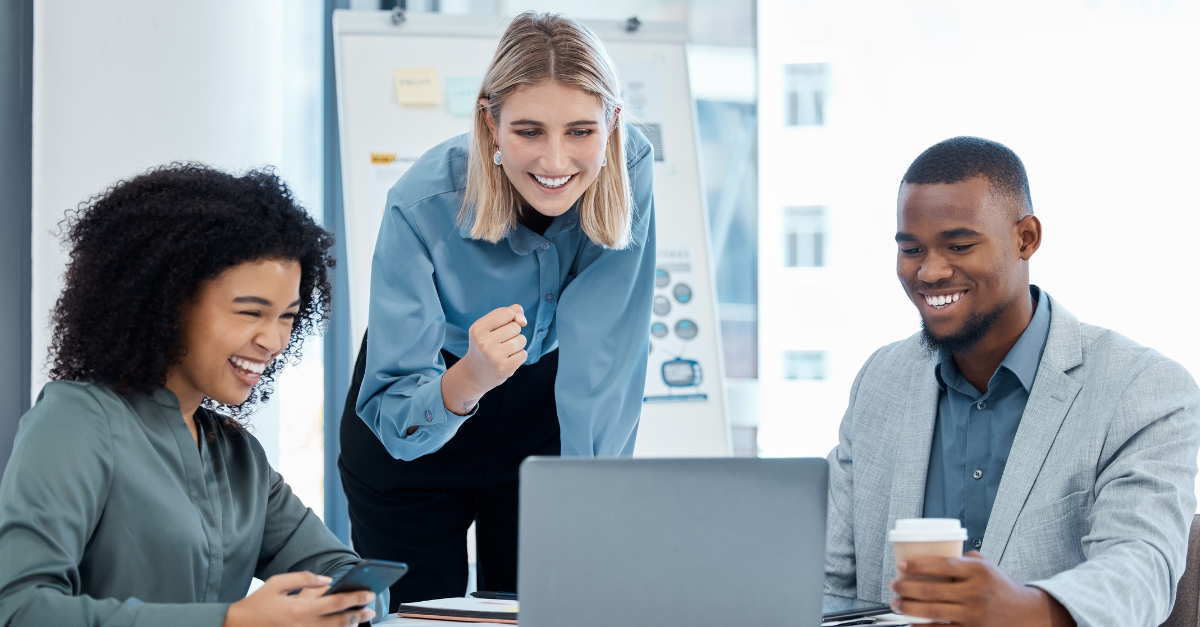 three professionals excited around computer